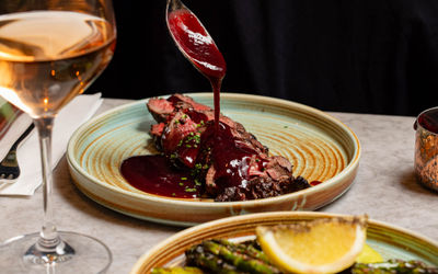 gravy being poured on steak