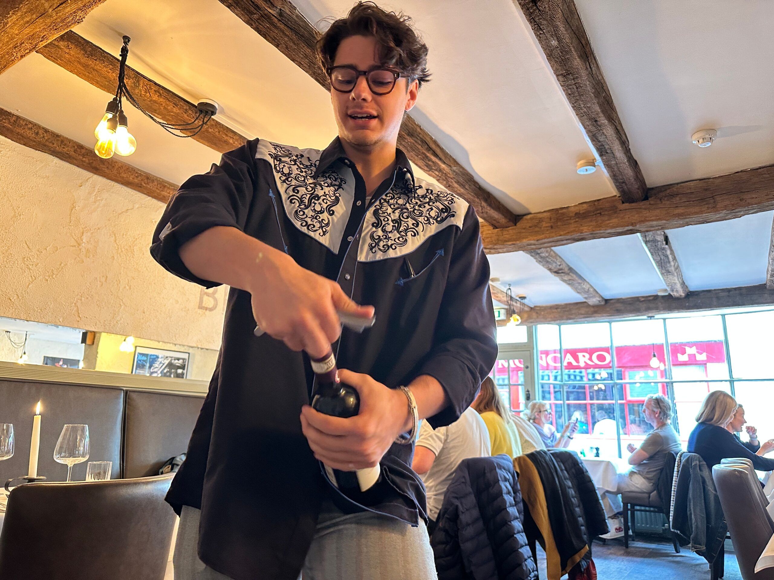 Gabriel opening bottle at Il Bistro