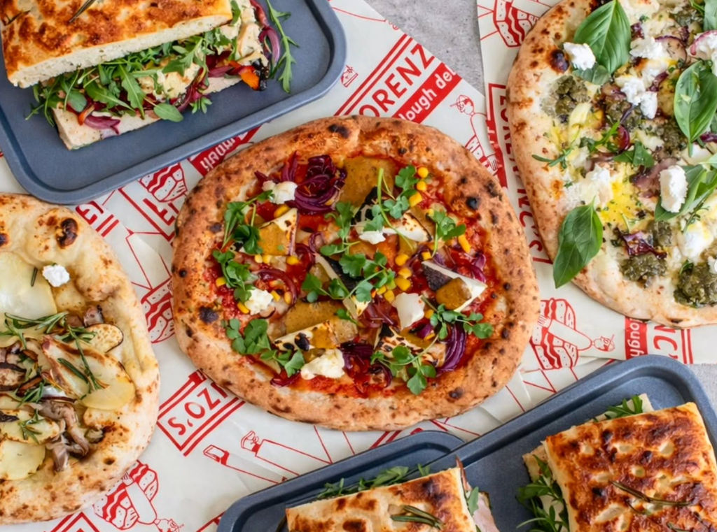 Lorenzo's Dough Deli - Pizza Brighton. a variety of pizzas photographed together. placed on paper table cloth