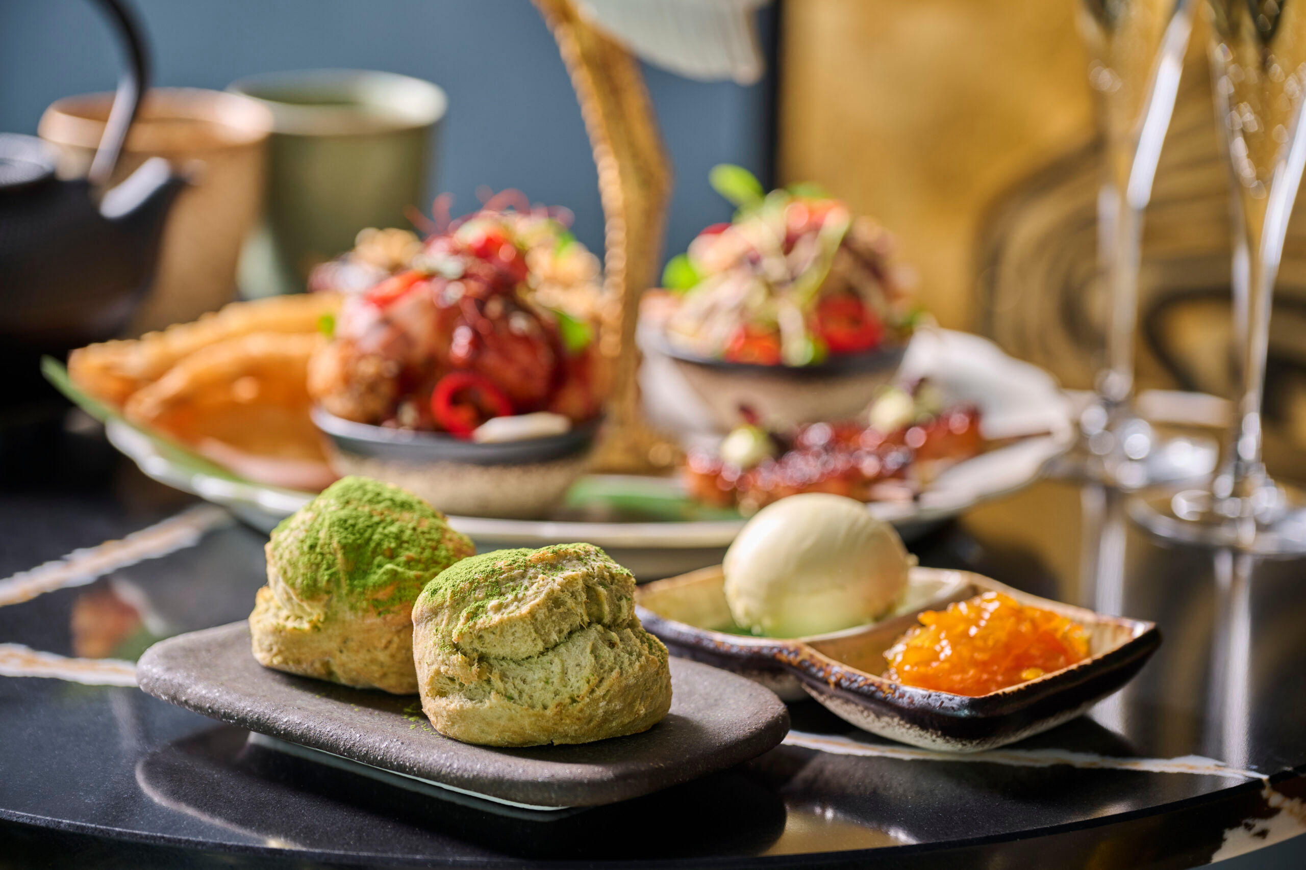 Japanese inspired afternoon tea at Sora. Malmaison. Colourful dishes of food presented on black plates. 