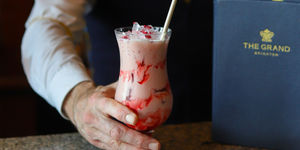 A pink and red cocktail is served at the bar of The Grand hotel in Brighton.
