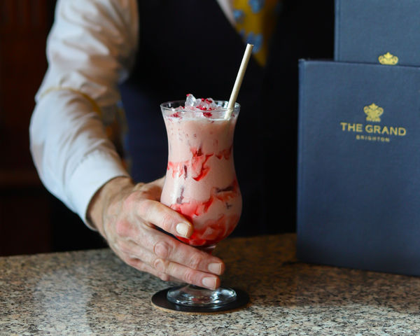 A pink and red cocktail is served at the bar of The Grand hotel in Brighton.