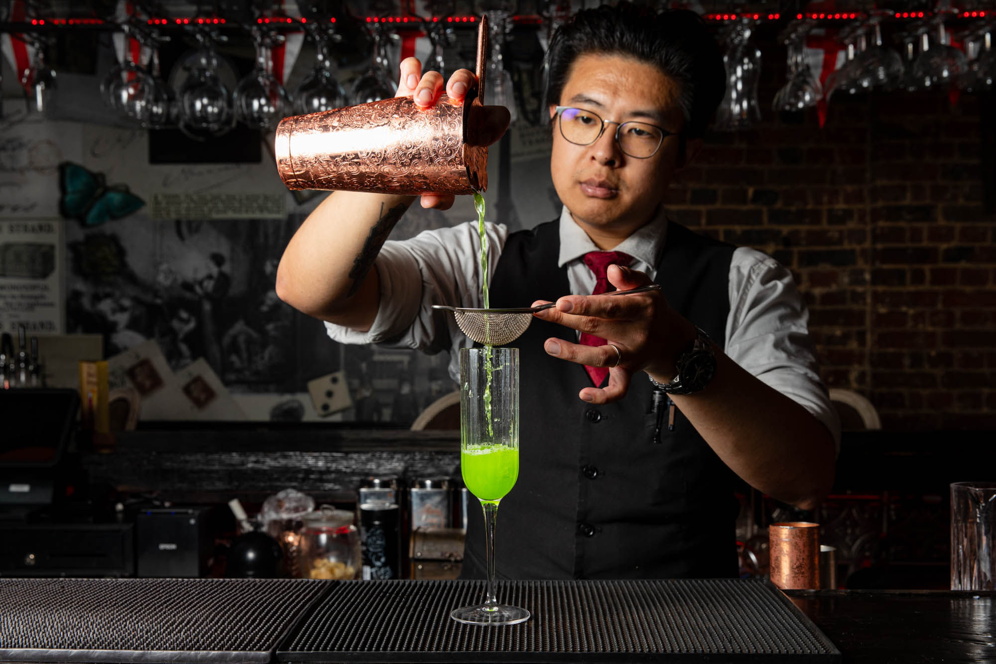 bartender preparing green cocktail at Bohemia