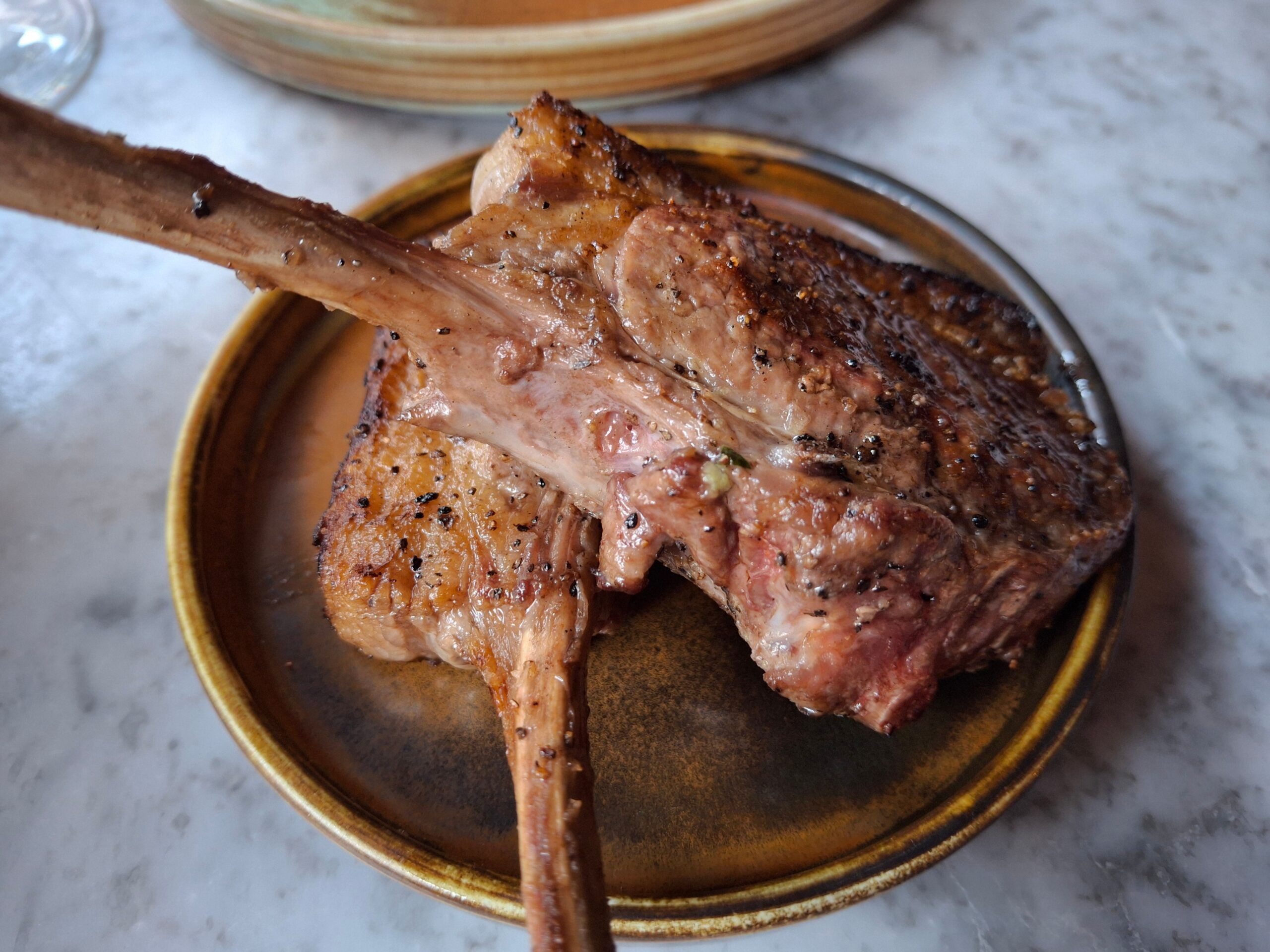 close up shot of meat served on plate at Kindling