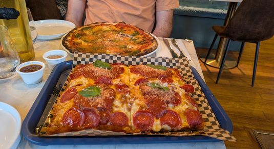 two type of pizzas on the table including Just Goat Serious’ on a Romano base, and a ‘Pepperoni’ Detroit-style pizza.