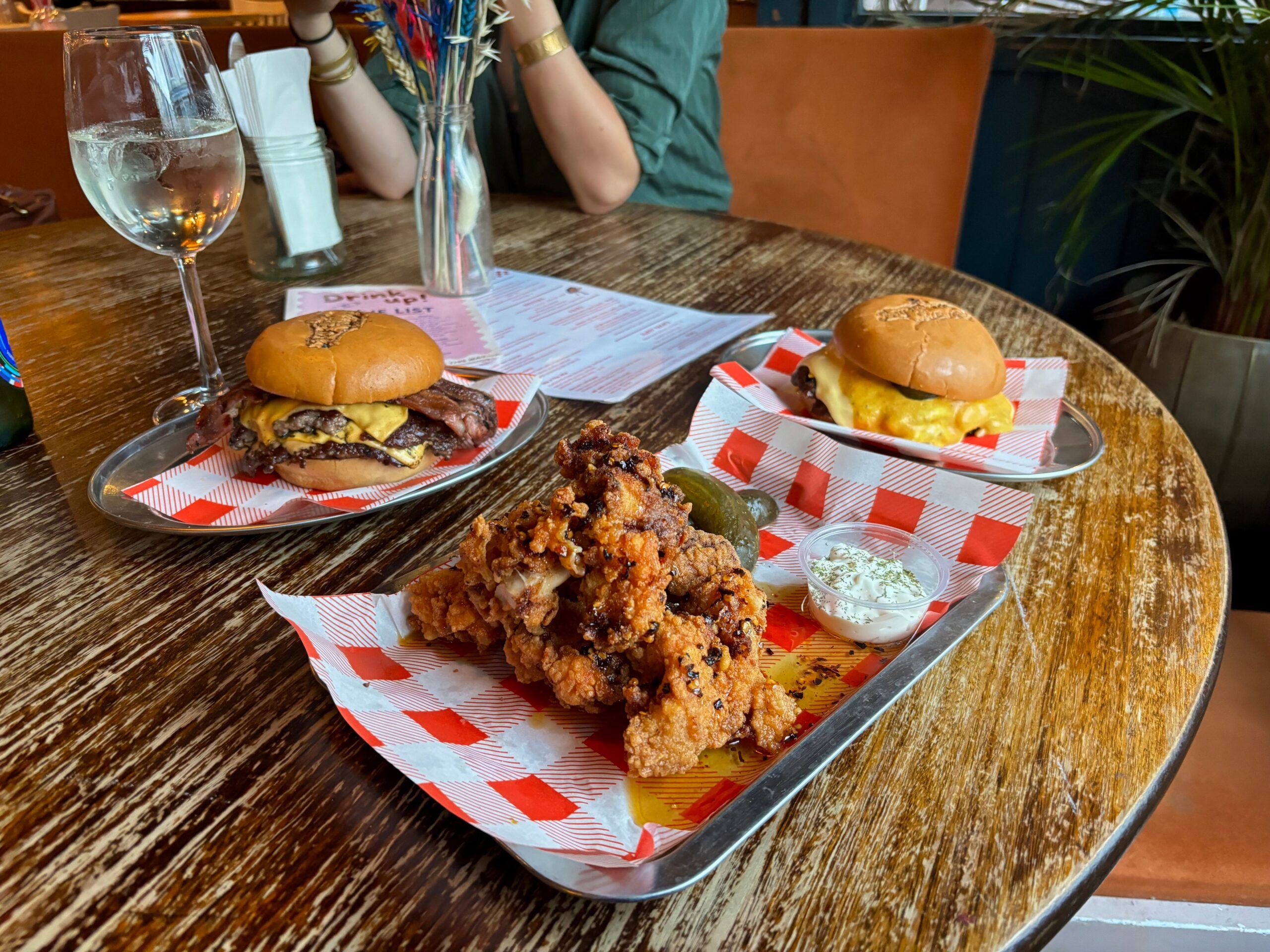 two burgers and chicken tenders on the table