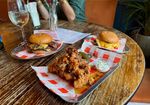 two burgers and chicken tenders on the table