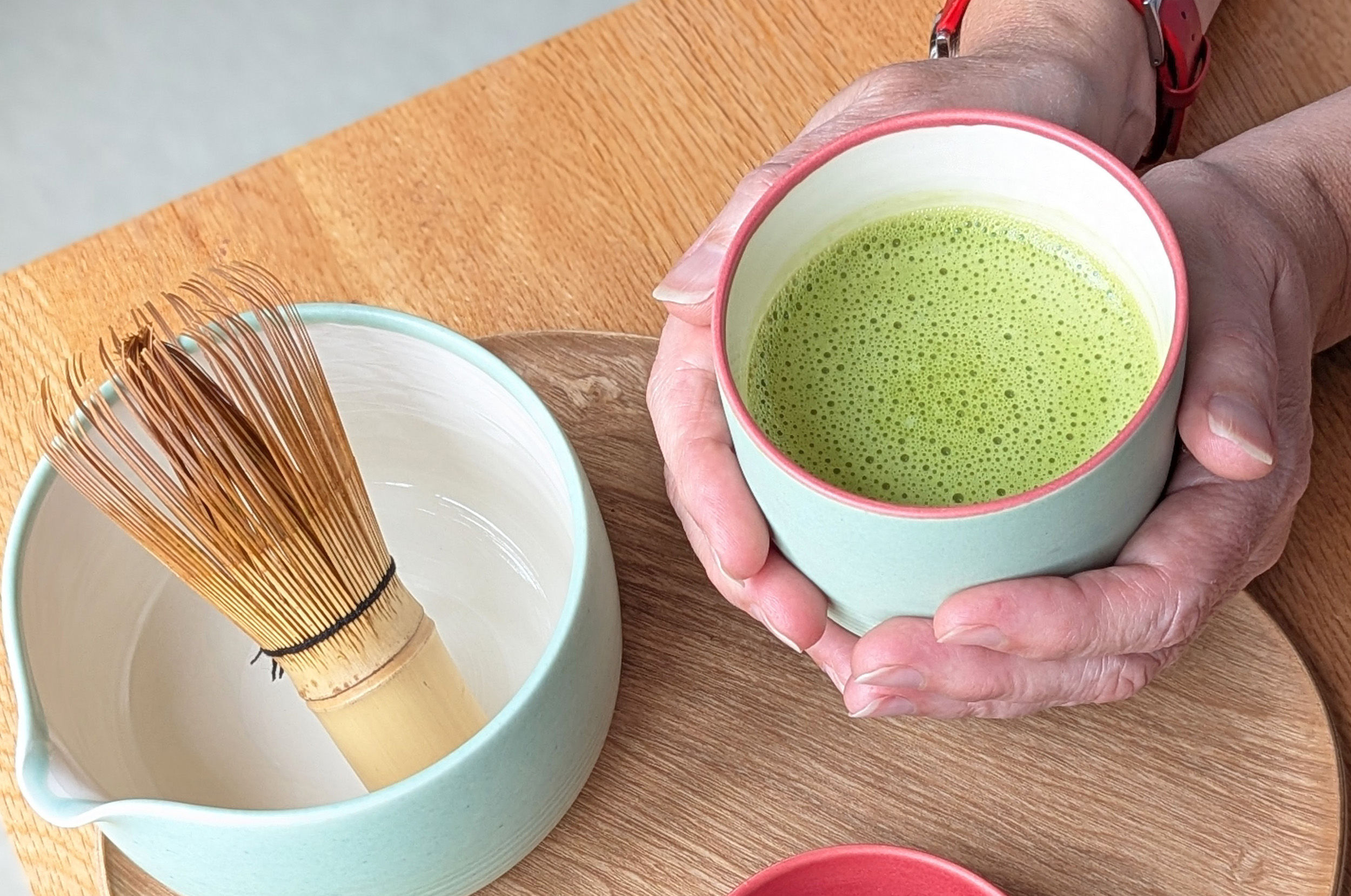 a hand embracing Matcha Japanese tea
