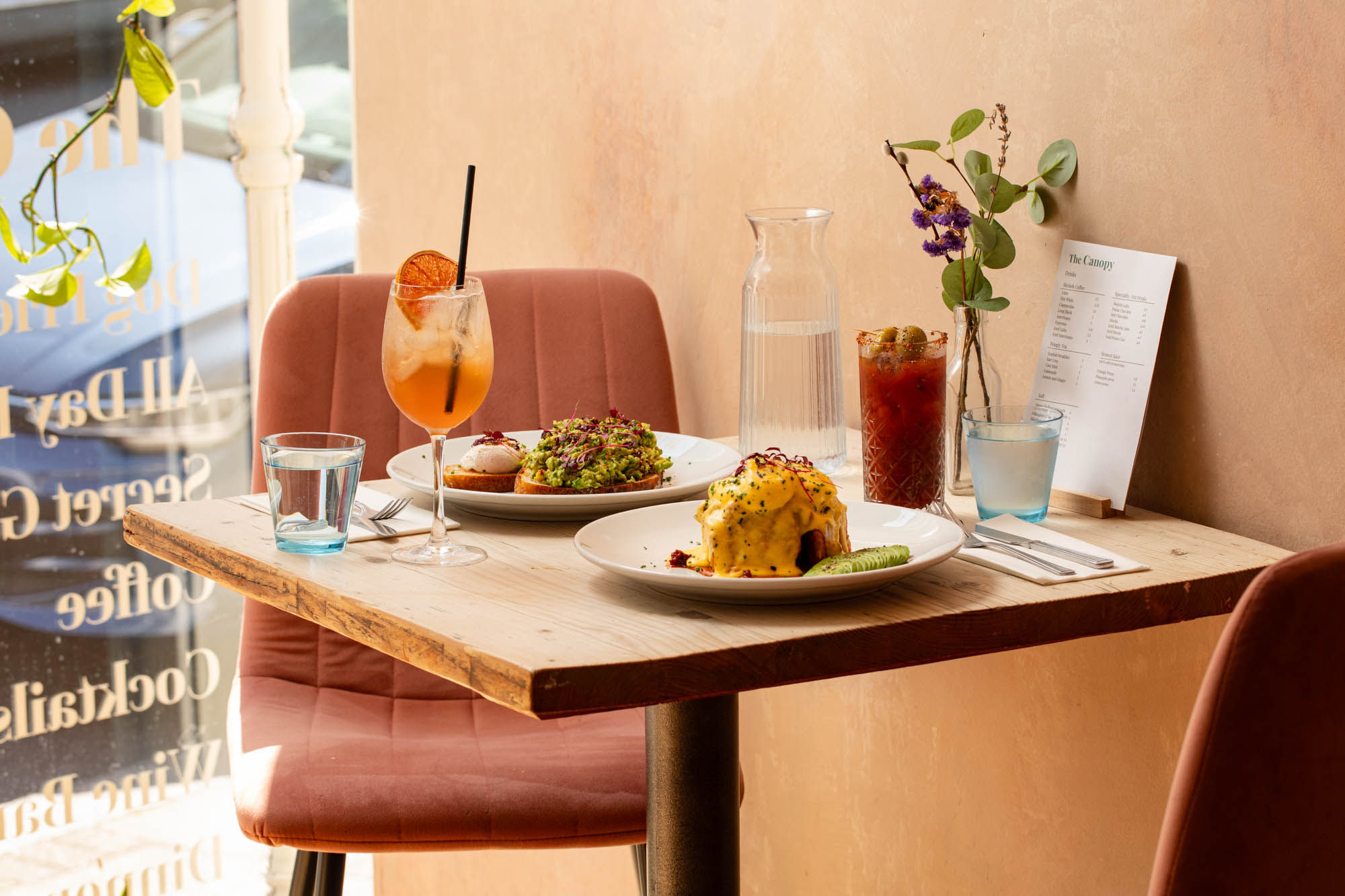 side shot of the table with breakfast dishes and cocktails