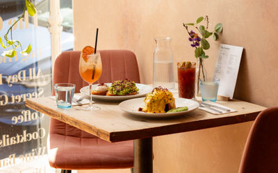side shot of the table with breakfast dishes and cocktails