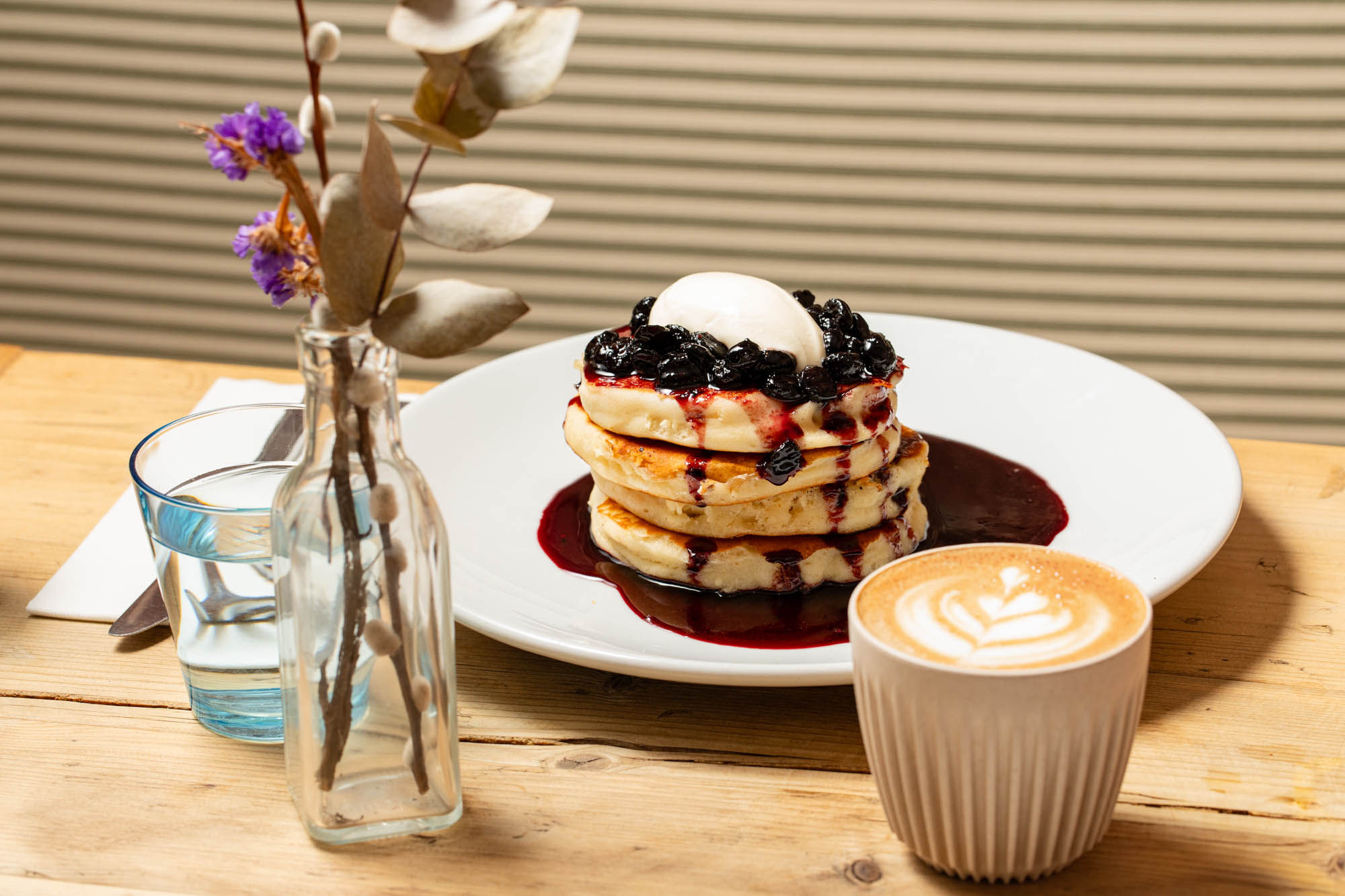 shot of the pancakes with syrup and blueberries