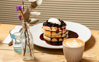 shot of the pancakes with syrup and blueberries