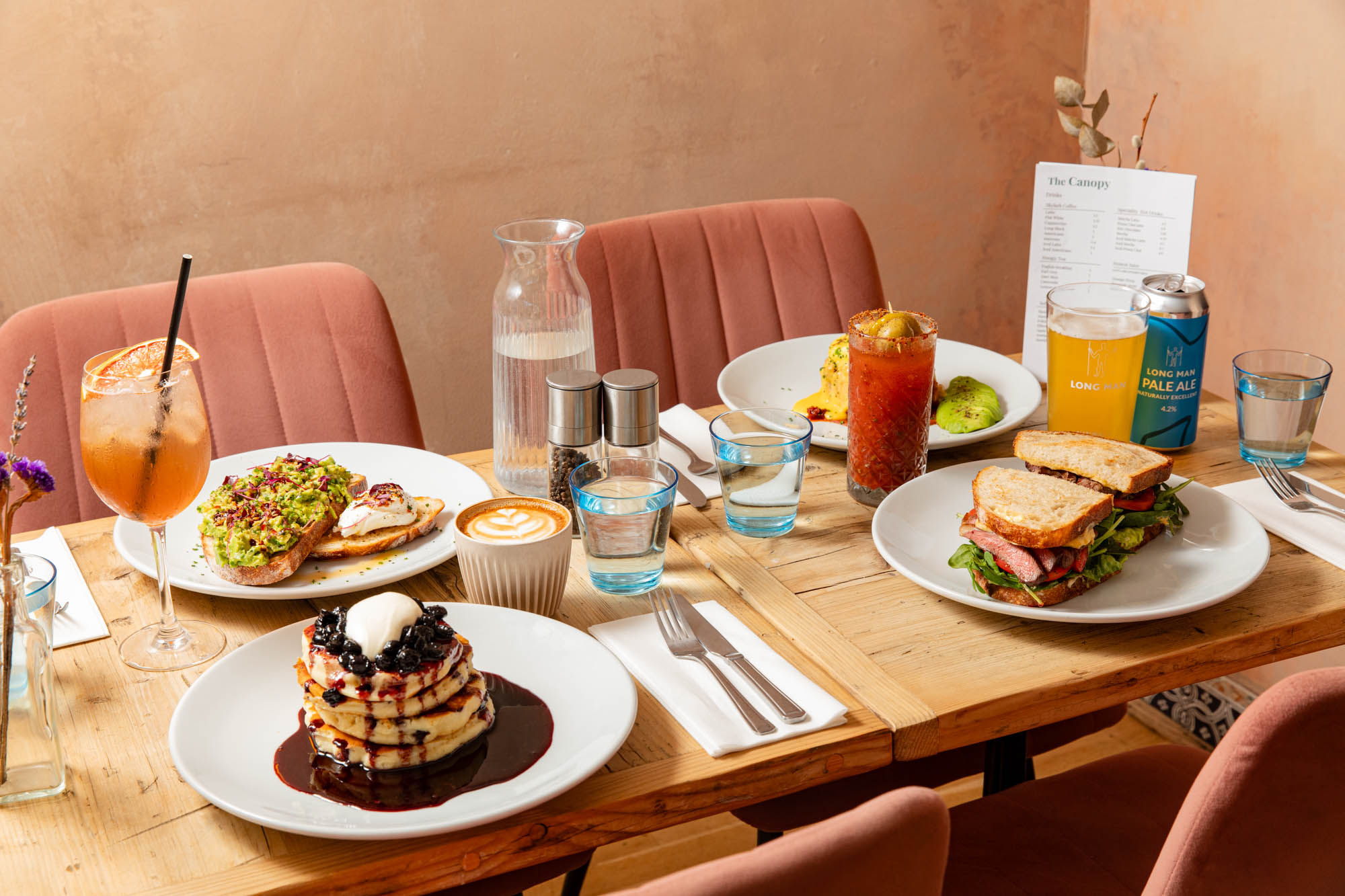 side shot of the table laid out with brunch dishes at The Canopy 