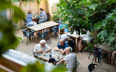 people dining in the Canopy garden, alfresco dining