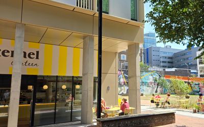 the yellow and white striped facade of Kernel Canteen - Circus Street