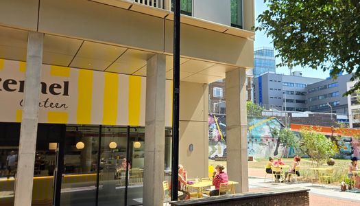 the yellow and white striped facade of Kernel Canteen - Circus Street