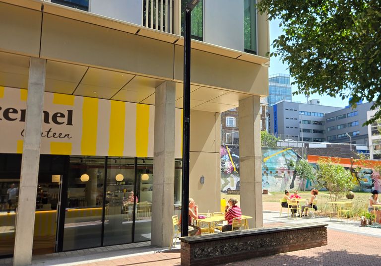 the yellow and white striped facade of Kernel Canteen - Circus Street