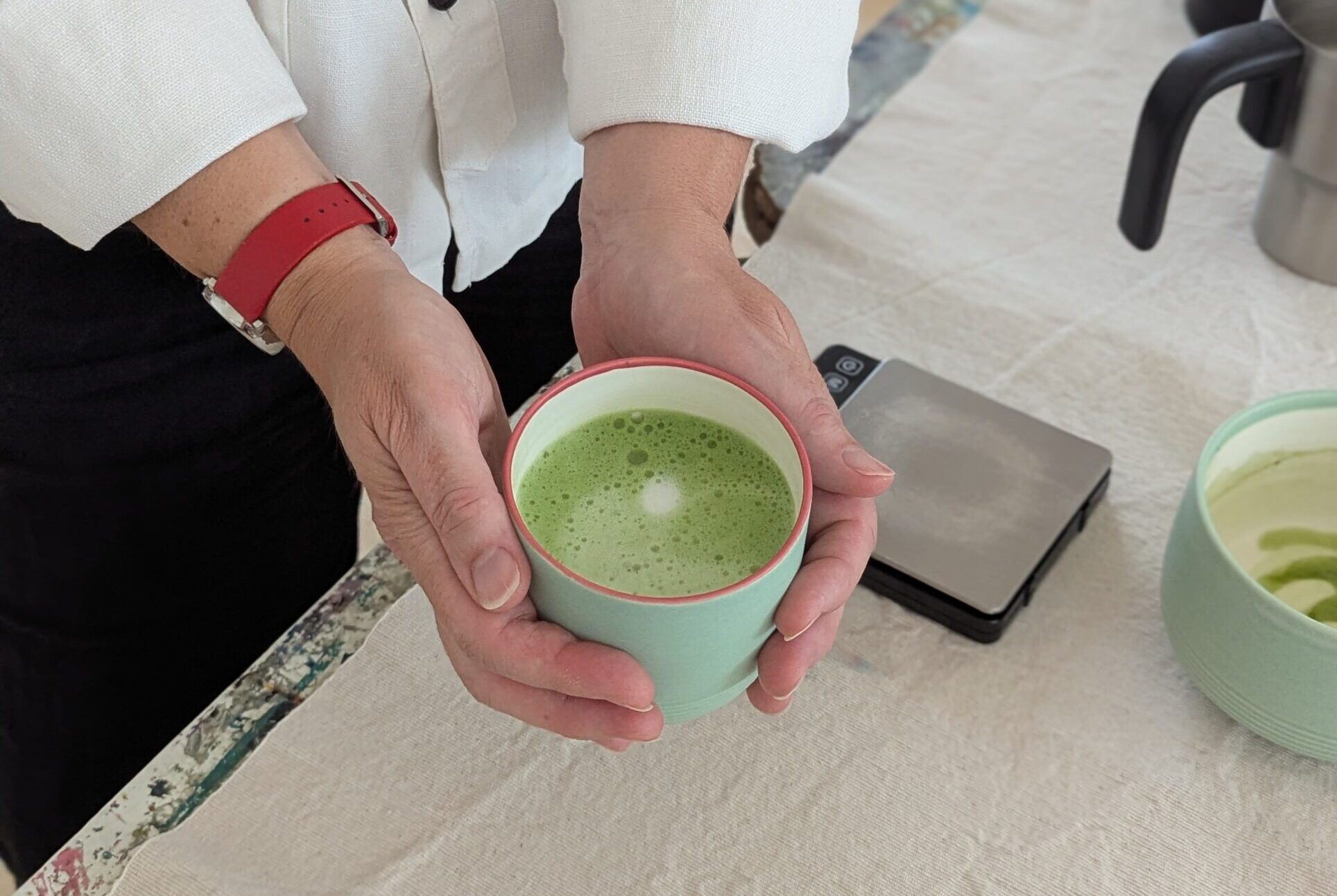 hands holding matcha cup