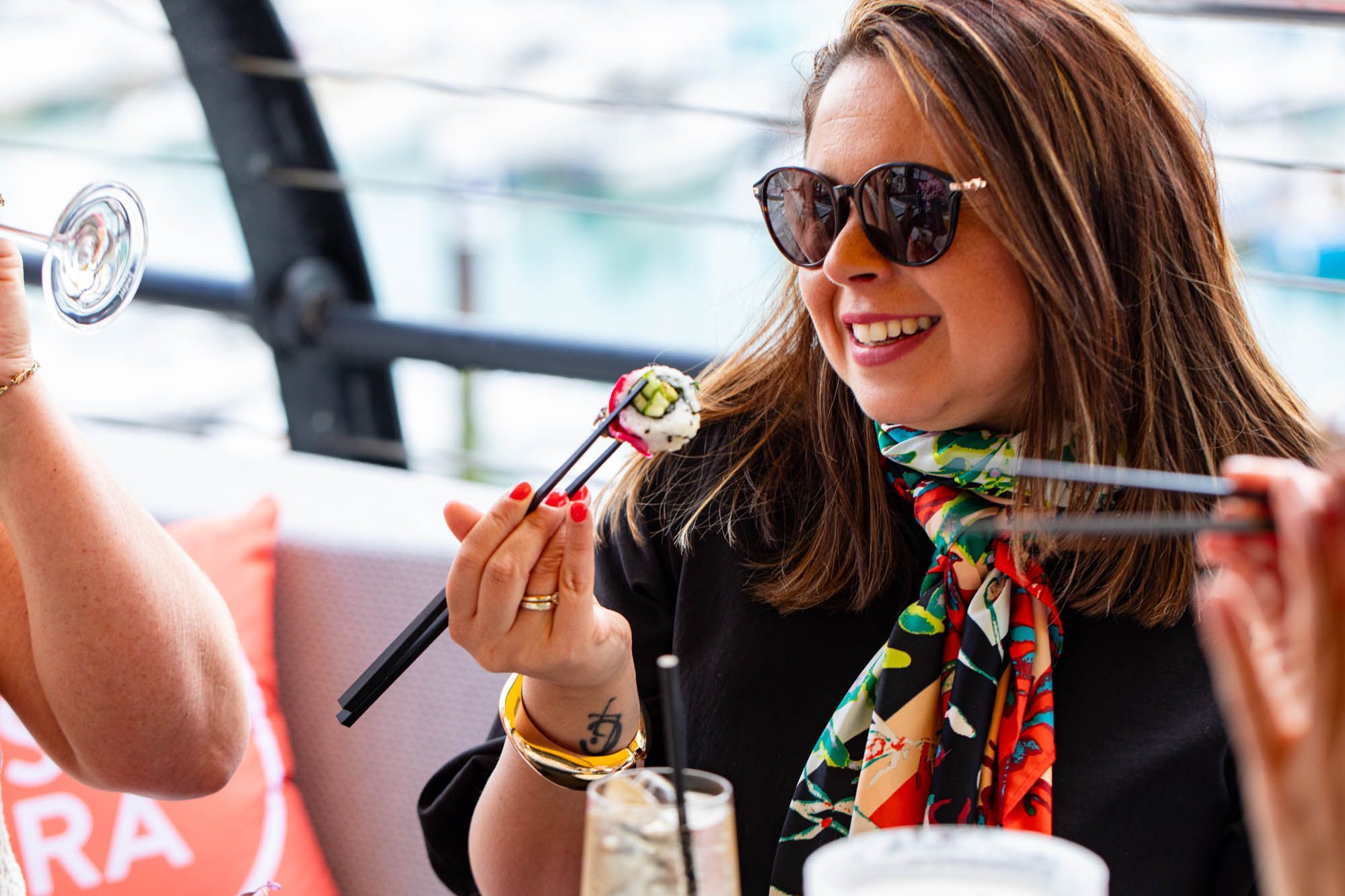 woman smiling and enjoying her sushi at Malmaison