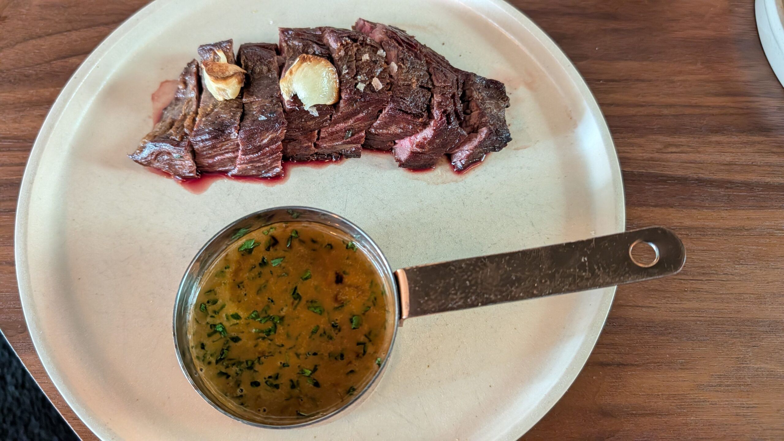 bavette served medium rare with a jug of mellow, silky peppercorn sauce.