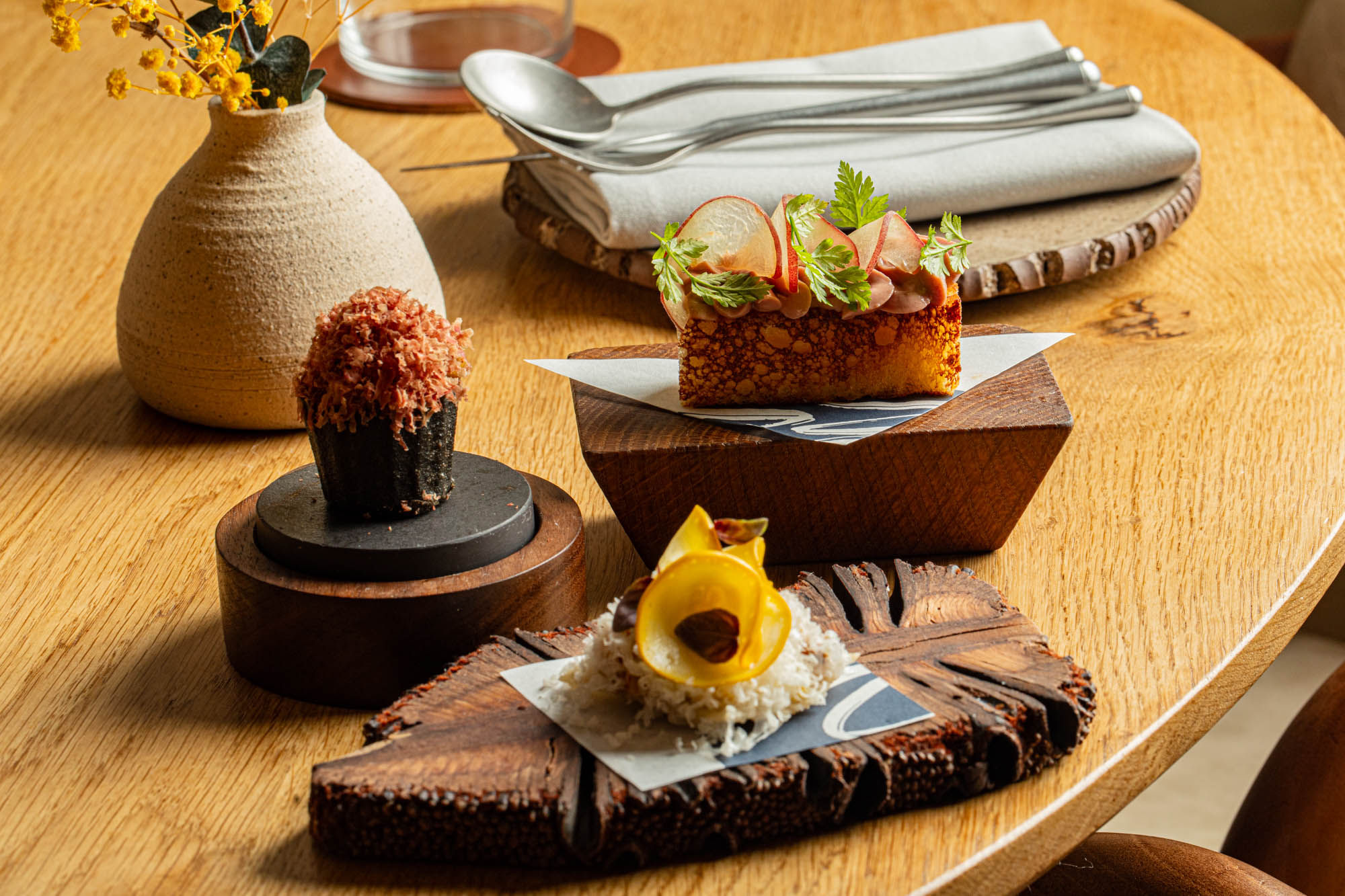 side shot of few dishes served on wooden boards