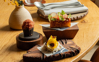 side shot of few dishes served on wooden boards