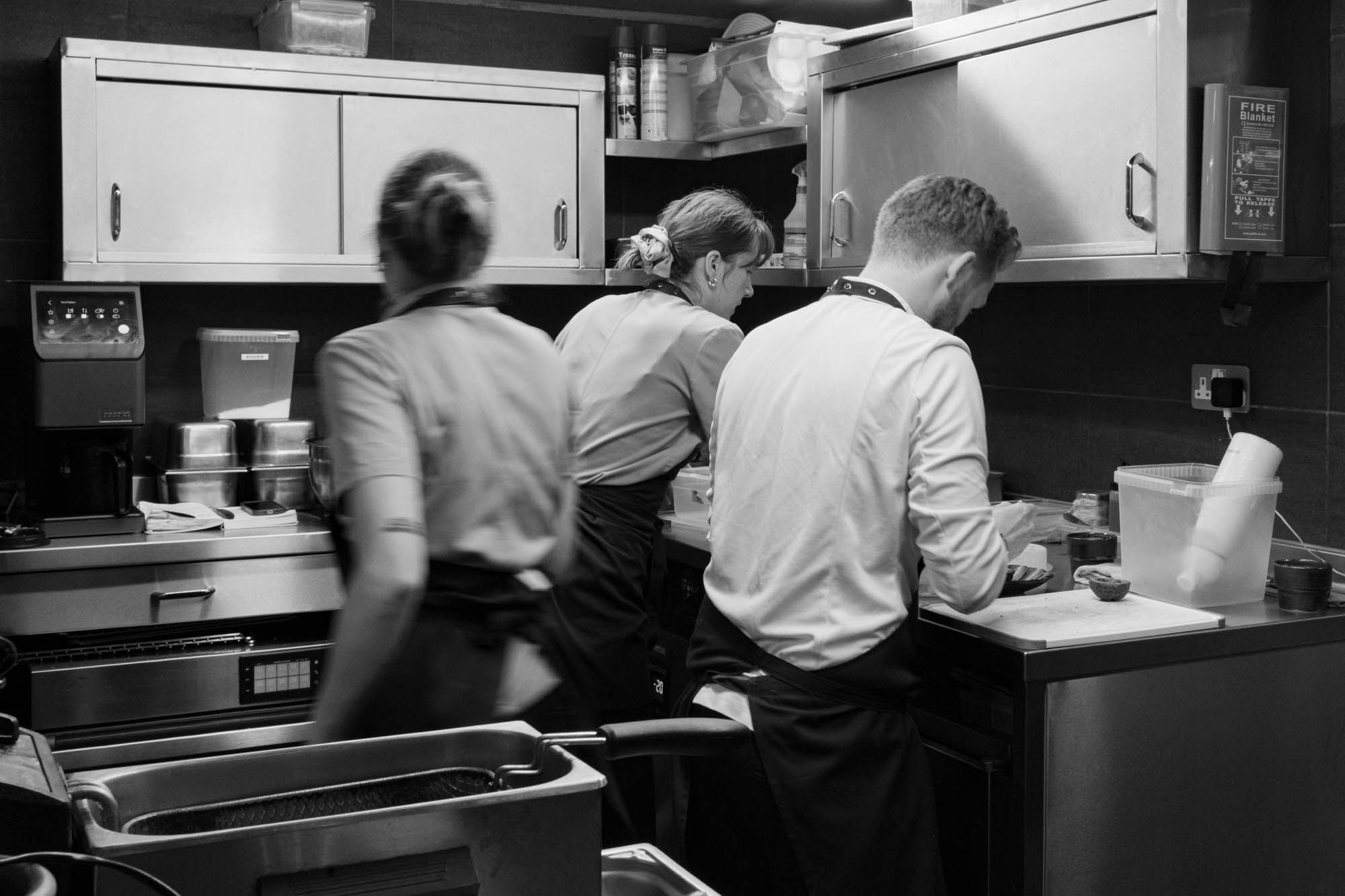 kitchen action shot at Maré, busy chefs preparing the food in kitchen