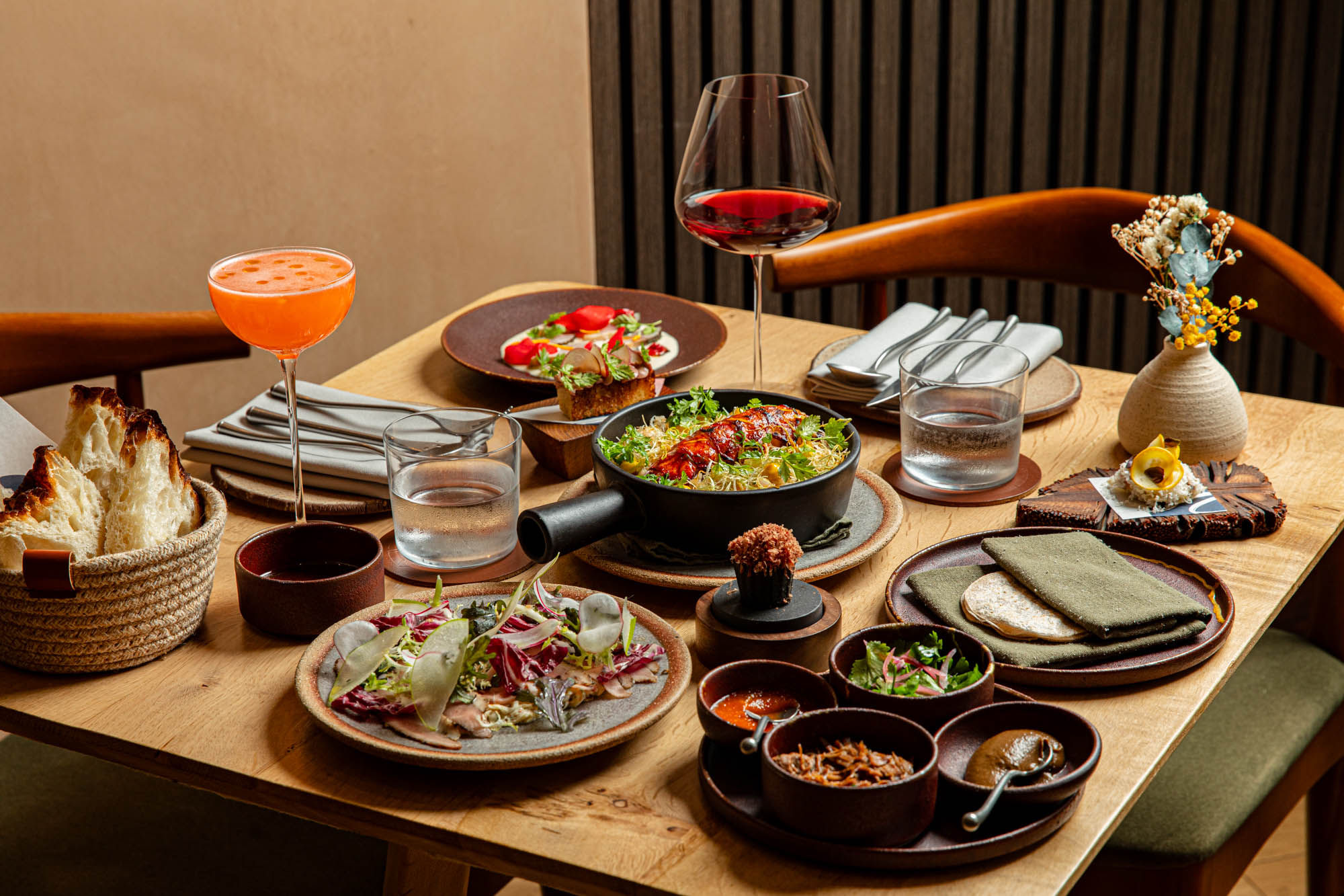 side shot of the table populate with couple of dishes and drinks