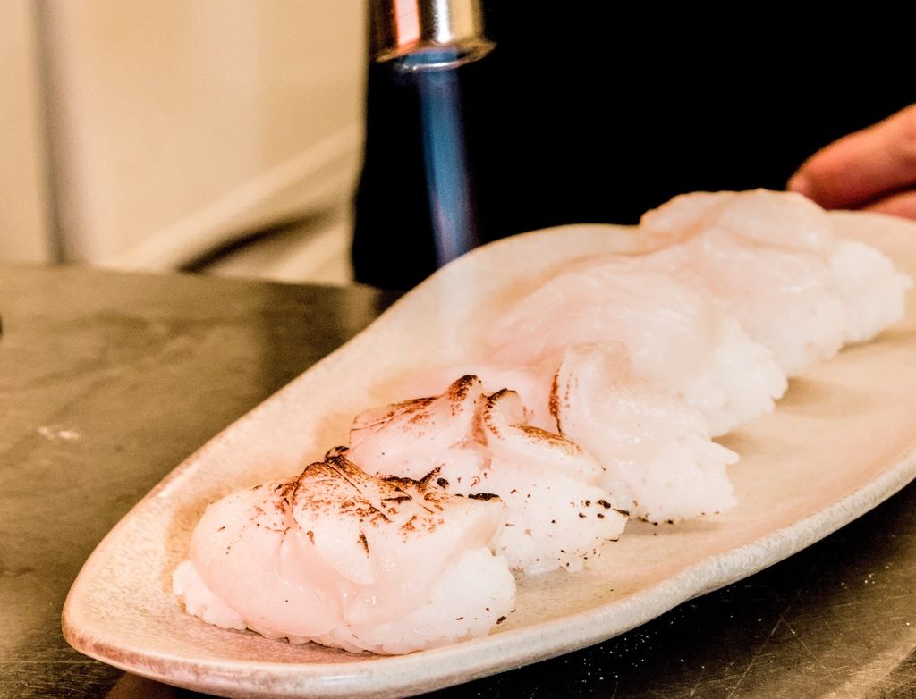 blow torch and sushi. Chef preparing dishes