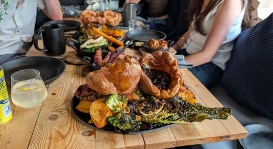 table laid out with couple of roast at Embers Brighton
