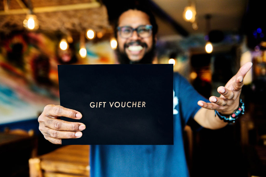 Naveen at The Coconut Island holding a Restaurants Brighton Gift Voucher