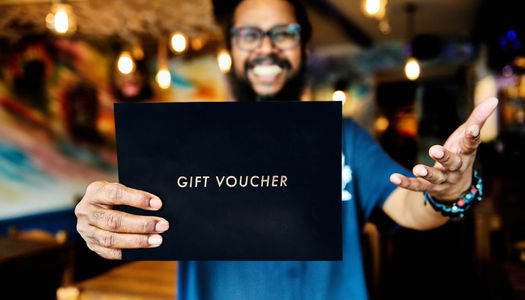 Naveen at The Coconut Island holding a Restaurants Brighton Gift Voucher