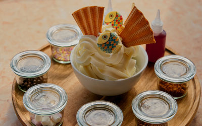 The Salt Room Fish Food Soft Serve To Share - Vanilla soft serve spinning on a lazy Susan with a parade of toppings: wafer fans, sprinkles, fudge pieces, marshmallows, chocolate & strawberry sauce.