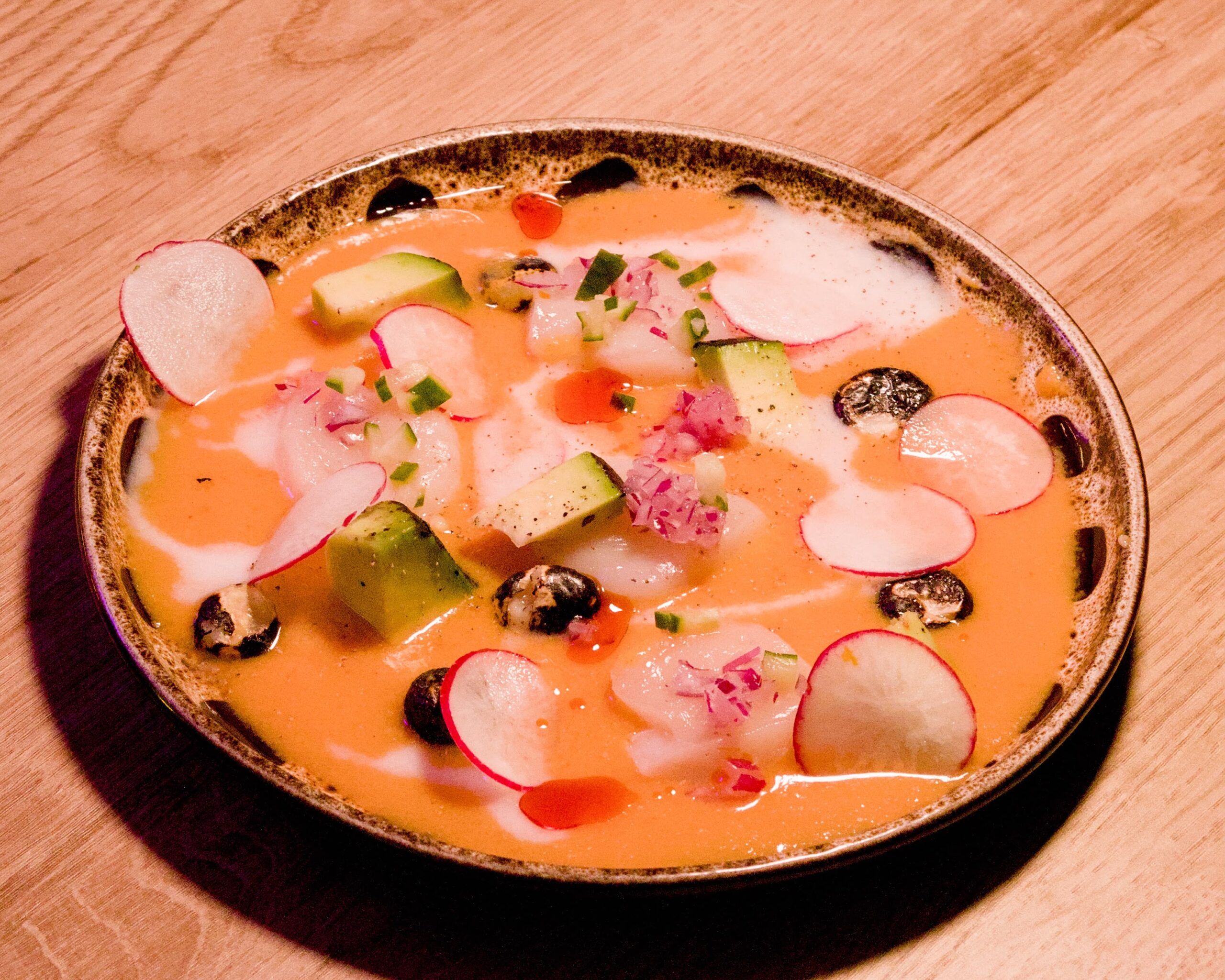 a ceviche dish - Japanese Peruvian cuisine in Brighton . A round plate beautifully decorated. 