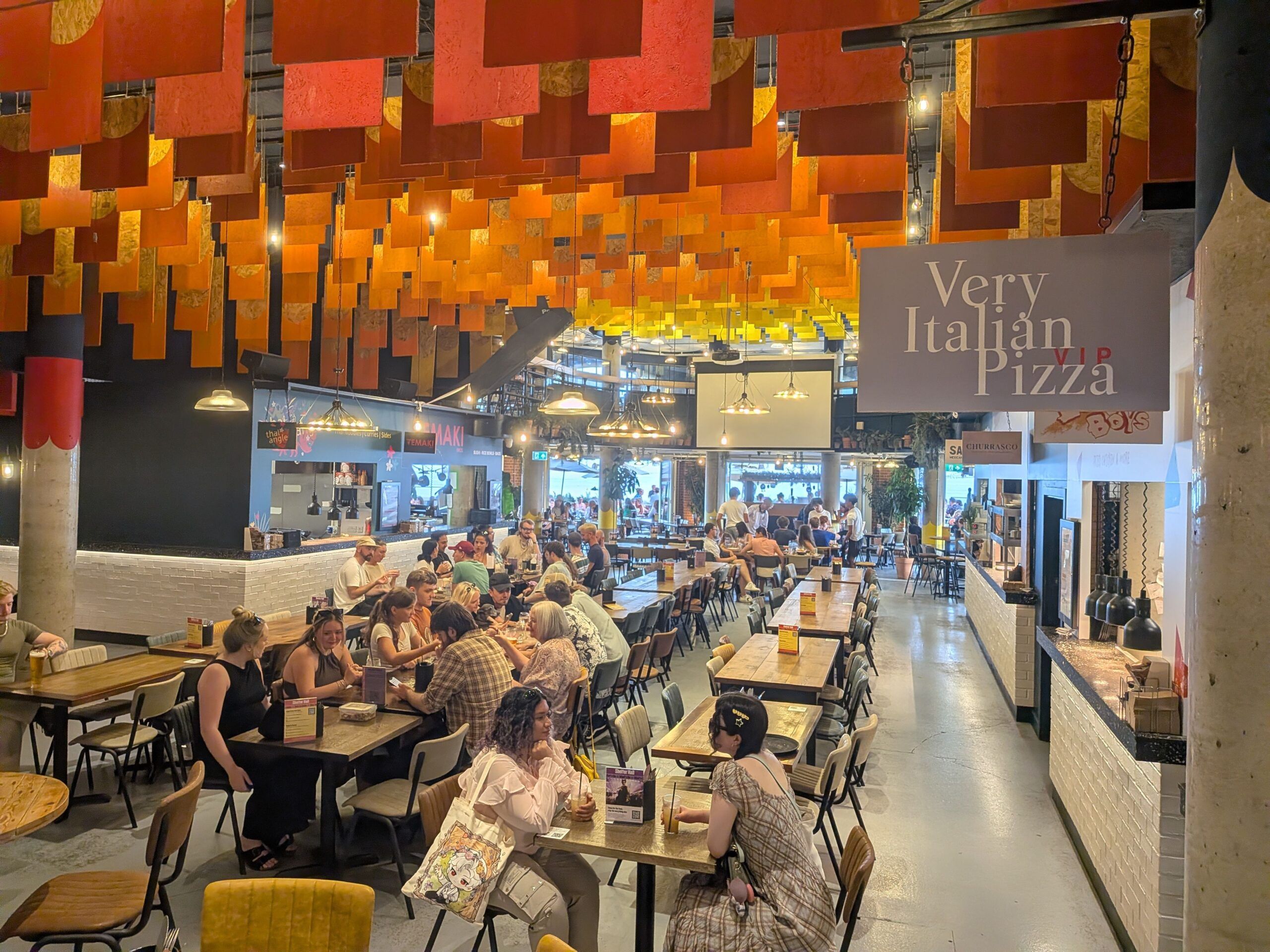 interior shot of Shelter Hall venue, people enjoying food and drink