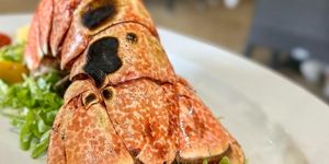a lobster tail. Restaurants on Brač, pictured lobster and salad at Konoba Kopaćina in Donji Humac