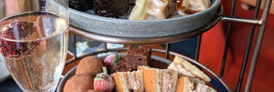 Two tiers of a Japanese tea with sushi and gyoza on the top tier.
