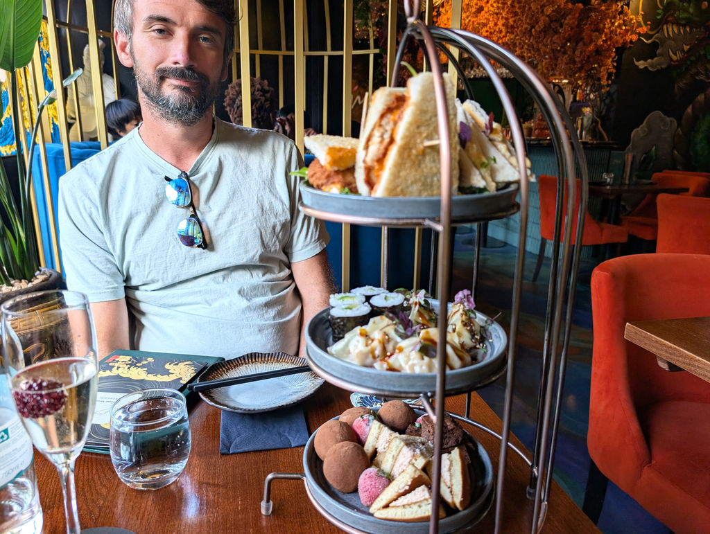 A three tiered Japanese tea with guest wearing a tea shirt.