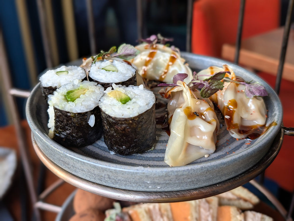 Sushi and gyoza on the top tier of a Japanese tea at Blossoms Brighton