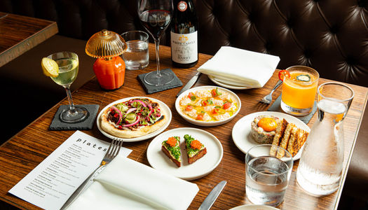 over head shot of the small plates, cocktails and wine served on the table at Plates Brighton