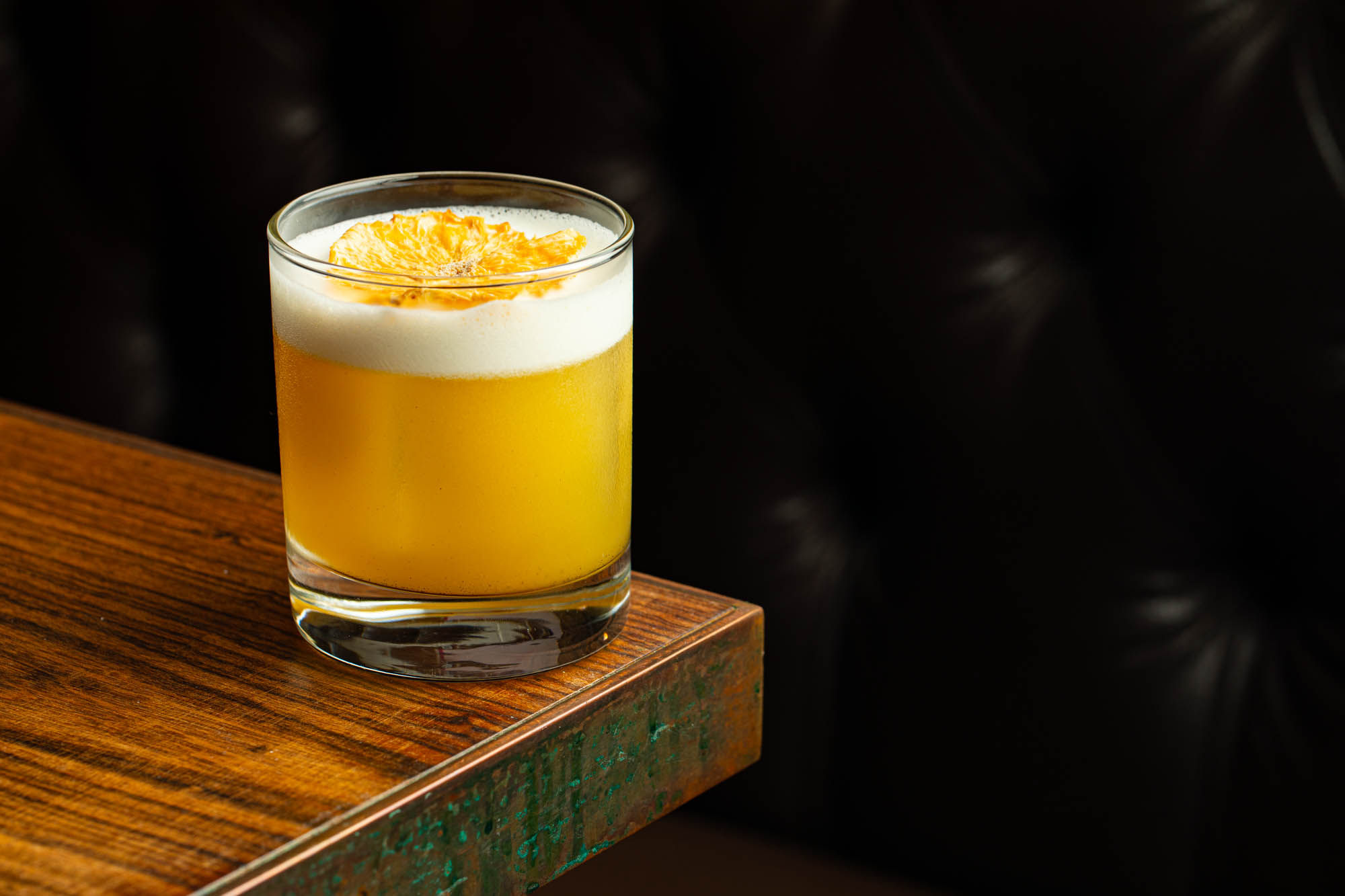 yellow cocktail on the edge of the table