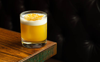 yellow cocktail on the edge of the table