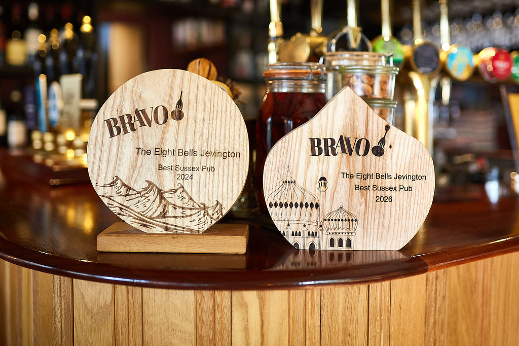 Two BRAVO award trophies sit on the bar of an award winning pub in Sussex called The Eight Bells, Jevington