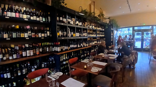 interior shot of fourth and church showcasing their wine shelves and tables