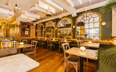 Inside Indian street food restaurant in The Lanes with warm fairy lights and dark green walls.
