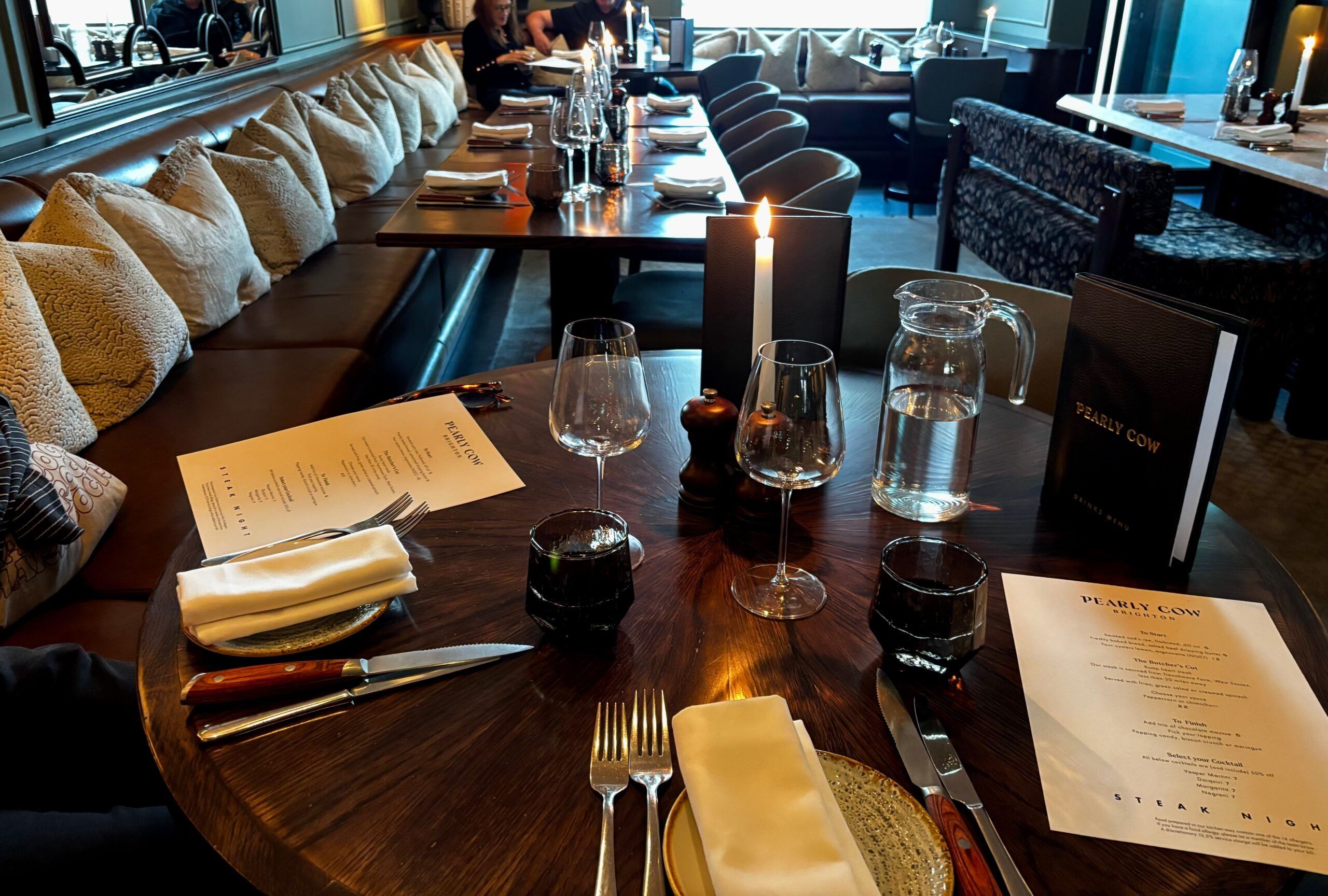 Pearly Cow Steak Night menu, shot of the laid out table for two people with steak night menu