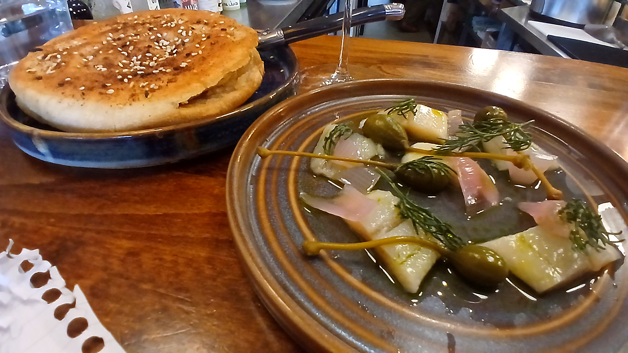 white pita snack with herring, pickled red onion and dill oil served at wine bar, Fourth and Church