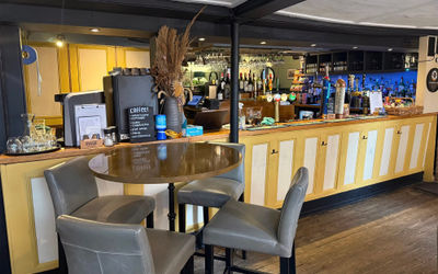 Interiors of a Sussex pub with yellow and white painted bar