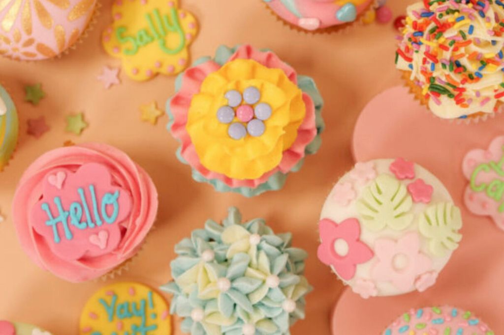 A picture full of pretty pastel decorated cupcakes