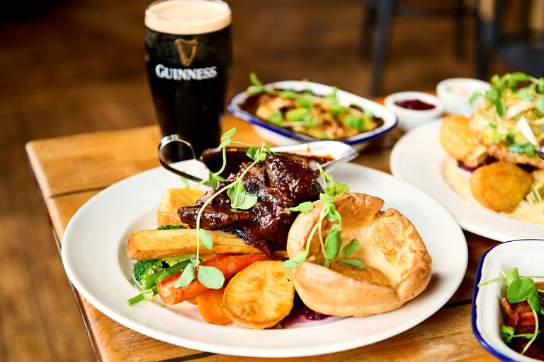 A Sunday roast with a pint of Guinness and sides